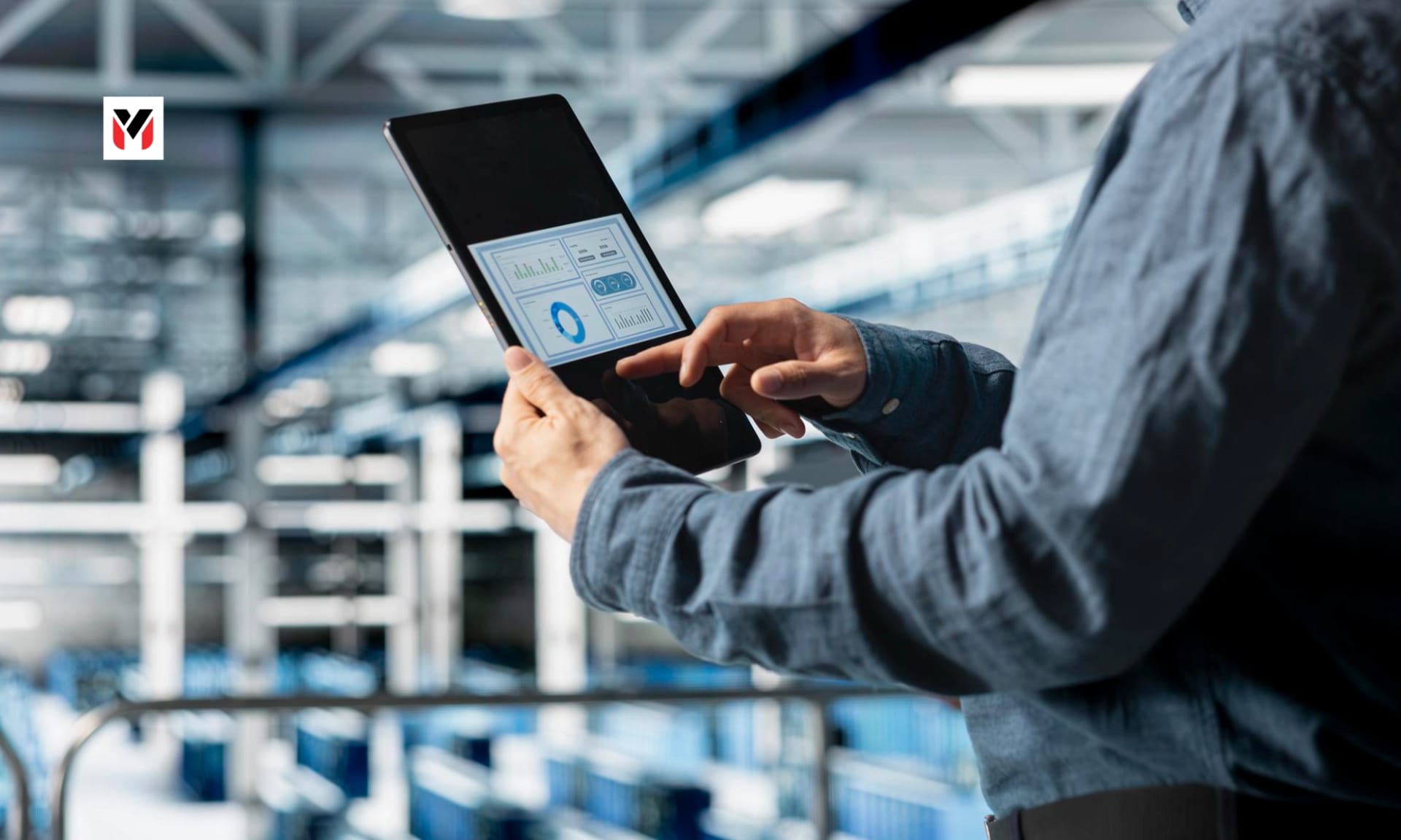 A small manufacturer checking an invoice on a tablet on the factory floor.